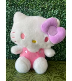 Cat Plush in Pink Overalls with Lavender Bow. An arrangement by Flower World and Gifts.
