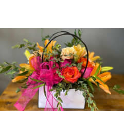 Sunset Bloom Purse. An arrangement by Blue Iris Florist.