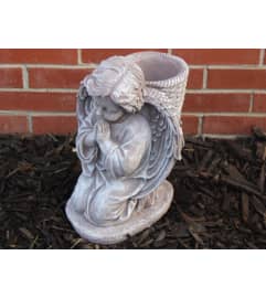 statue - Potted Cherub. An arrangement by Tom Rodgers Flowers.