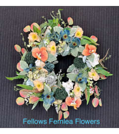 Muted Jewel Tones Artificial Wreath. An arrangement by Fellows Fernlea Flowers.