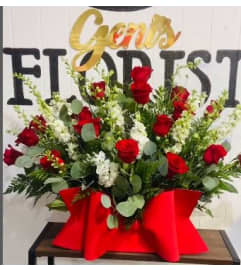 Scarlet and Ivory Embrace. An arrangement by Geni's Florist and Gifts.