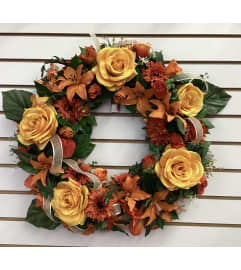 Fall Rose Wreath. An arrangement by Roma Flowers and Gifts.