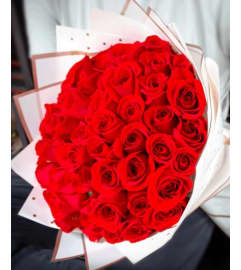 Hand-Tied Wrap Presentation Bouquet. An arrangement by Brickell Exclusive Blooms.