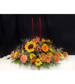 Thanksgiving Centerpiece with Candles. An arrangement by Marianne's Floral Garden. Thanksgiving Centerpiece with Candles. An arrangement by Marianne's Floral Garden.