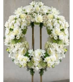 Pure White Wreath. An arrangement by Geni's Florist and Gifts. Pure White Wreath. An arrangement by Geni's Florist and Gifts.