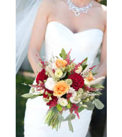 Bridal bouquet Red and Peach. An arrangement by Flowers and Beyond.