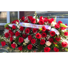 Red Rose Tribute Casket Spray. An arrangement by Tom's Florist.