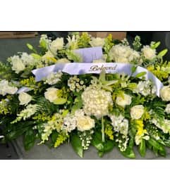 Beloved White Garden Casket Spray. An arrangement by Tom's Florist.