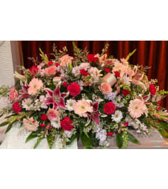 Pink and Crimson Remembrance Casket Spray. An arrangement by Tom's Florist.