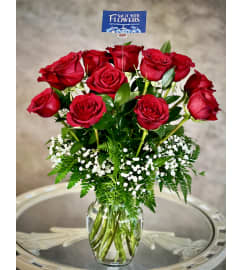 Classic look with 12 red roses. An arrangement by Say It With Flowers. Classic look with 12 red roses. An arrangement by Say It With Flowers.