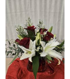 Crimson and Lily Whisper. An arrangement by Special Touch Florist.