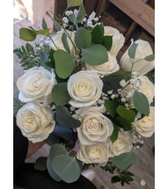 A dozen white rose bouquet. An arrangement by DMP Flowers and Gifts.