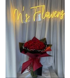 RED ROSE CLUTCH BOUQUET. An arrangement by M's Flowers.