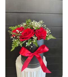 8 Red roses in Luxe Hat Box. An arrangement by Marianna's Flower Island.