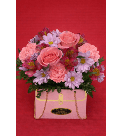 Purse of Love. An arrangement by Bee Flowers.