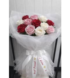Pink and Red Roses Wrapped. An arrangement by Geni's Florist and Gifts.