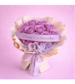 Lavender Roses Wrap. An arrangement by Geni's Florist and Gifts.