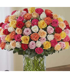 100 ASSORTED ROSE BOUQUET IN VASE. An arrangement by KW Flowers.