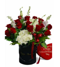 Scarlet and Ivory Embrace. An arrangement by Geni's Florist and Gifts.