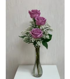THREE PURPLE ROSES IN A VASE. An arrangement by Flowers by Priscilla.