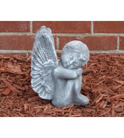 Sitting Angel. An arrangement by Sueppel's Flowers. Sitting Angel. An arrangement by Sueppel's Flowers.