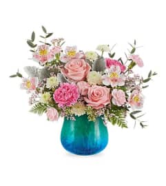 Teleflora's Blue Hues arrangement in blue aqua vase. An arrangement by Nicol Florist.