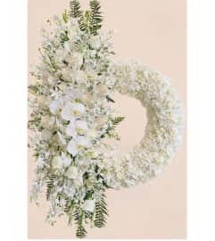 Pure White Beauty Wreath. An arrangement by Geni's Florist and Gifts.