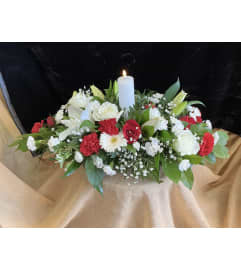Flameless Candle Centerpiece. An arrangement by Roma Flowers and Gifts.