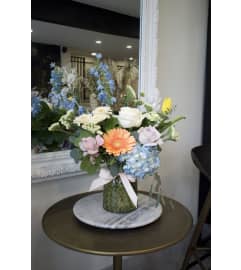 Pastel designer's choice in a diamond vase. An arrangement by Enchanted Florist.