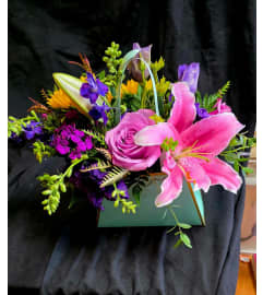 Purse Full of Posies. An arrangement by Rosemar Flowers and Gifts.