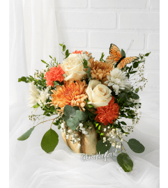 Apricot and Ivory Ceramic Pumpkin Centrepiece. An arrangement by Brooklin Floral and Garden Shoppe Inc..
