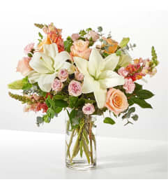 Elegant Lily and Rose Harmony. An arrangement by Leland Florist.