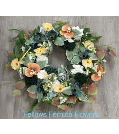 Muted Jewel Tones Wreath - faux. An arrangement by Fellows Fernlea Flowers.
