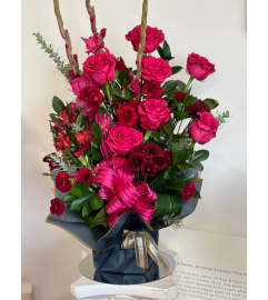 Crimson Embrace Arrangement. An arrangement by Berlin Flower Shop.