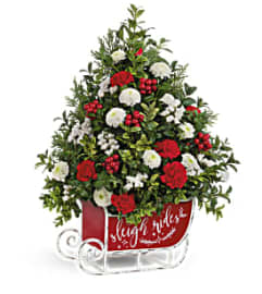 Teleflora's Festive Sleigh Tree Bouquet. An arrangement by Margaret's Florist.