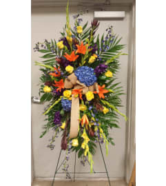 SPRING MEDLEY EASEL. An arrangement by Gary's Floral Gallery.