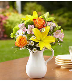 Fields of Europe™ in White Ceramic Pitcher. An arrangement by Blessing and Blooms Florist.