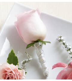 The FTD® Pink Rose Boutonniere. An arrangement by Mystic Garden Floral.