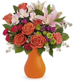 Teleflora's Happy Go Citrus Bouquet. An arrangement by Marivel's Florist and Gifts.