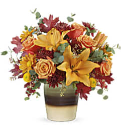Teleflora's Rustic Sunrise Bouquet with Roses. An arrangement by Marivel's Florist and Gifts.