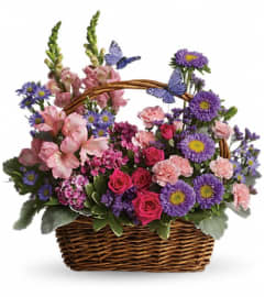 Country Blooms in a Basket. An arrangement by Flower Trends Florists.
