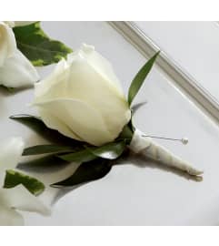 The FTD® White Rose Boutonniere. An arrangement by Syd Kemsley Florist.