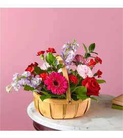 Pink Picnic Basket. An arrangement by Country Cousins Flower Shop.