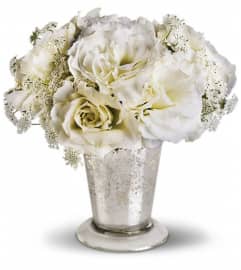 Teleflora's Angel Centerpiece. An arrangement by Marivel's Florist and Gifts.