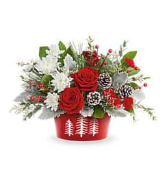 The Teleflora's Snowy Pines Centerpiece. An arrangement by Marivel's Florist and Gifts.