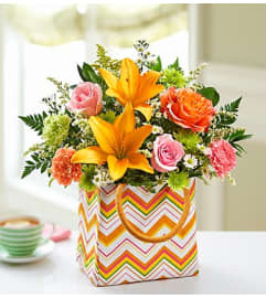 Summer Garden Tote. An arrangement by Blessing and Blooms Florist.