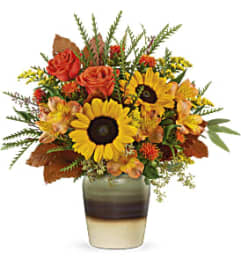 Teleflora's Thankfully Yours Bouquet with Sunflowers. An arrangement by Marivel's Florist and Gifts.