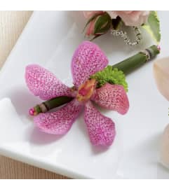 The FTD® Pink Mokara Boutonniere. An arrangement by Mystic Garden Floral.