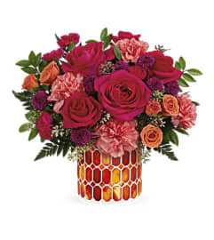 The Teleflora's Sunset Blooms Bouquet. An arrangement by Marivel's Florist and Gifts.