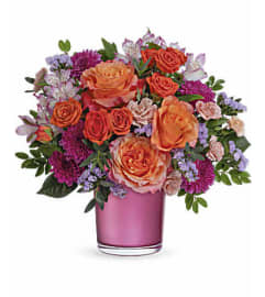 The Teleflora's Sunset Serenade Bouquet. An arrangement by Marivel's Florist and Gifts.